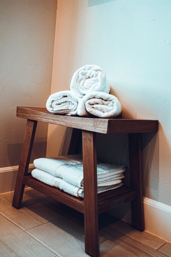 Neatly arranged towels on a wooden shelf