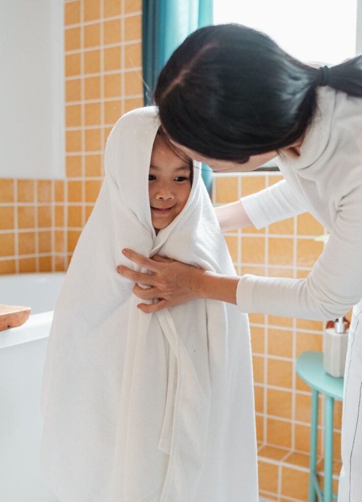 Child wrapped in a white cotton towel