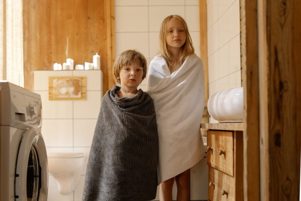 Children wrapped in soft towels after a bath