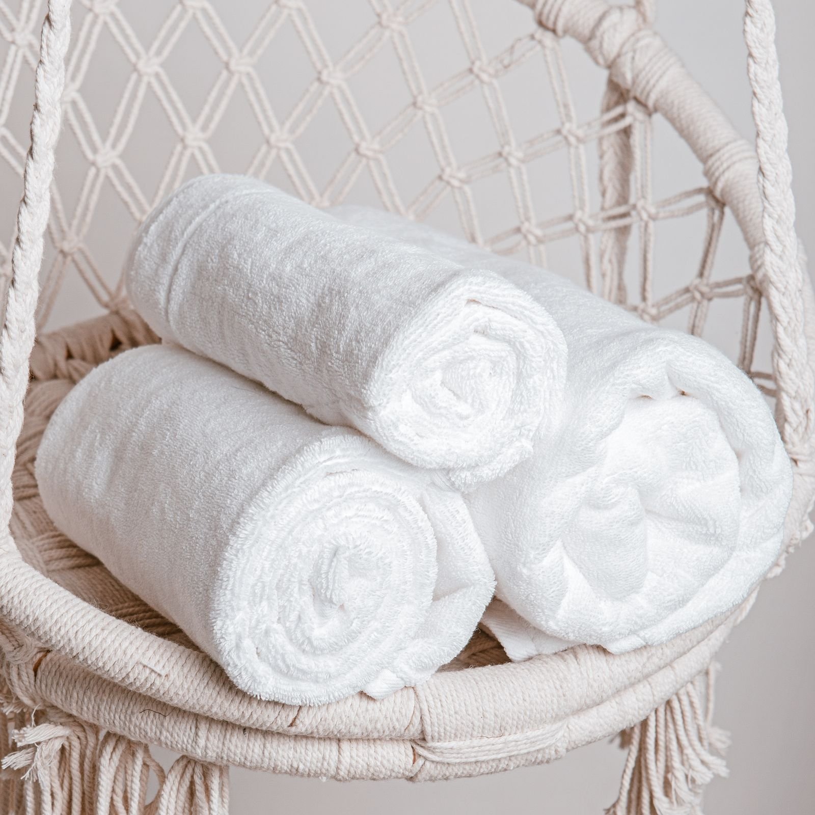 Three rolled white towels